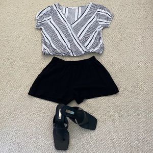 Beautiful black/white top faux wrap over, elasticated bottom.  Size small.